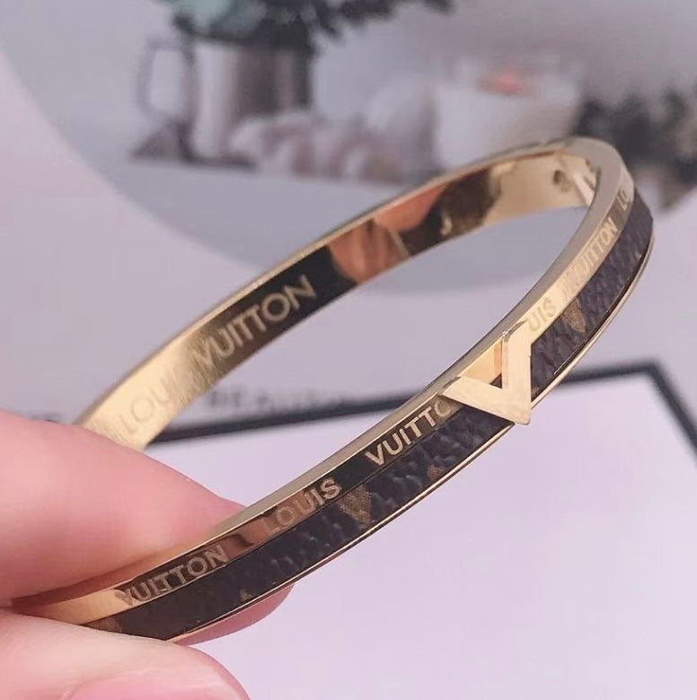 Bracelet Louis Vuitton doré avec cuir
